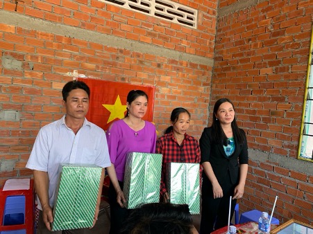 A group of people standing in front of a brick buildingDescription automatically generated